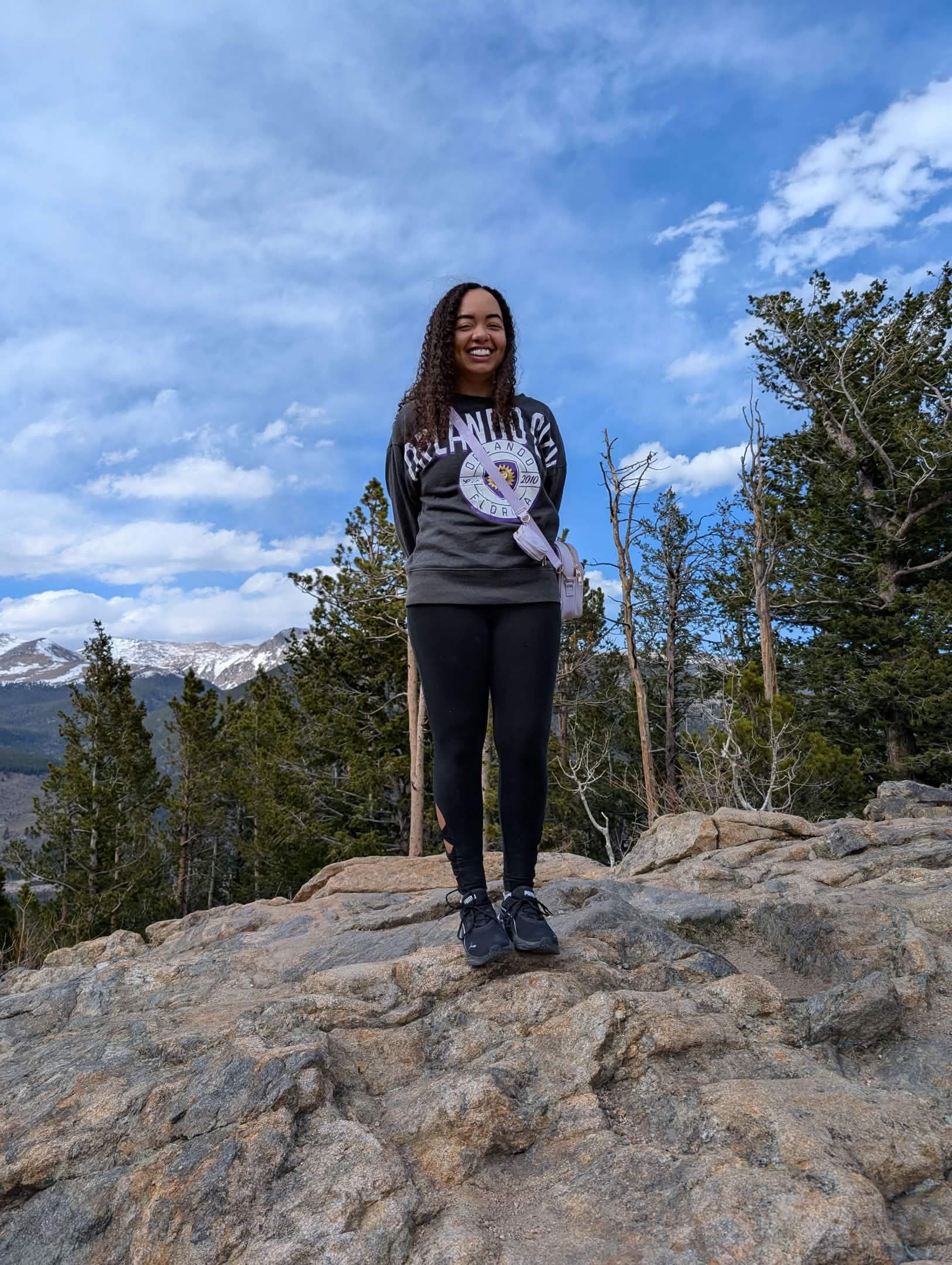 woman standing on rocks in Estes Park
