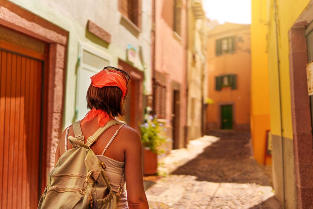 solo female traveler walking through a narrow street